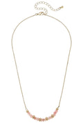 Necklace with pink beads in s crescent shape on a gold chain.